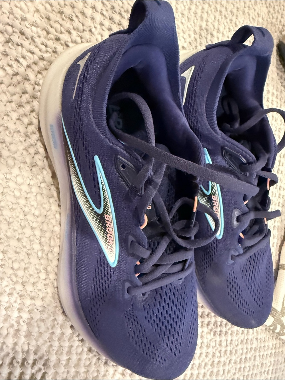 Brooks navy running shoes with light aqua accents